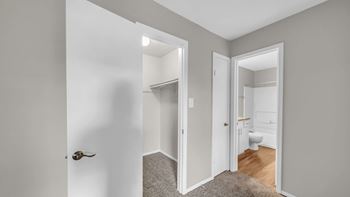 A white door is open to a bathroom.